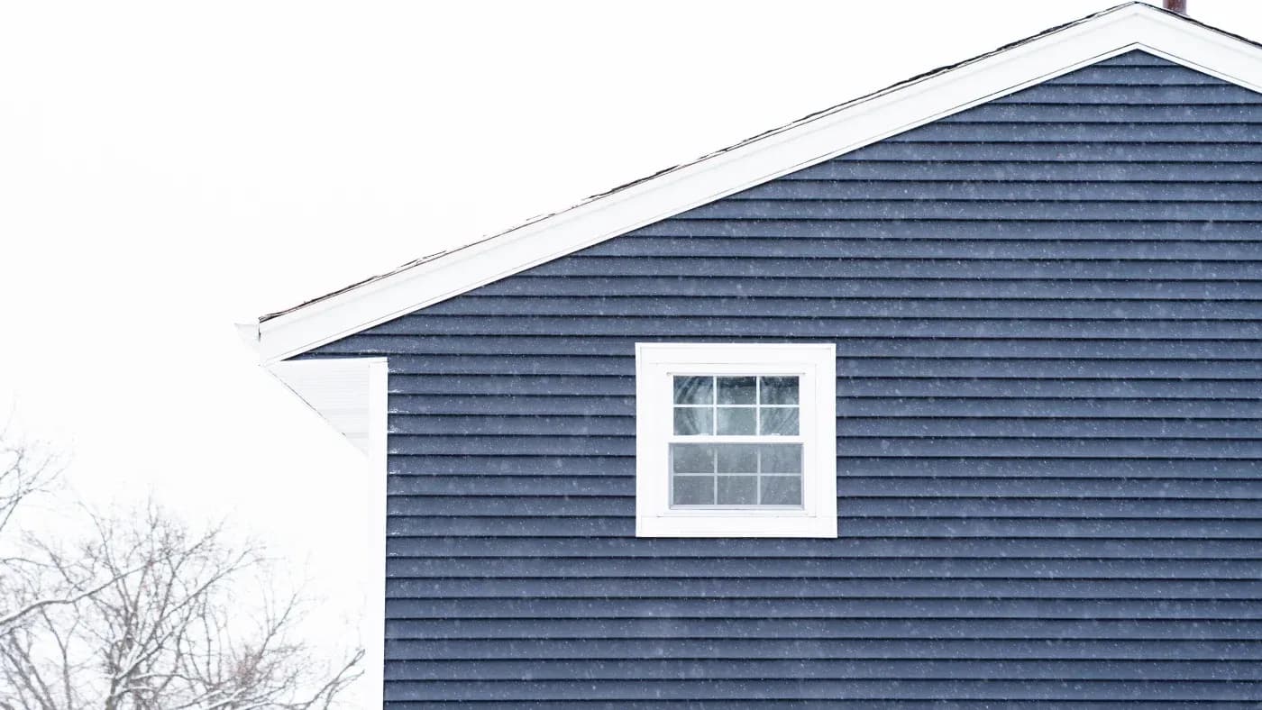 A home with blue siding and a white window